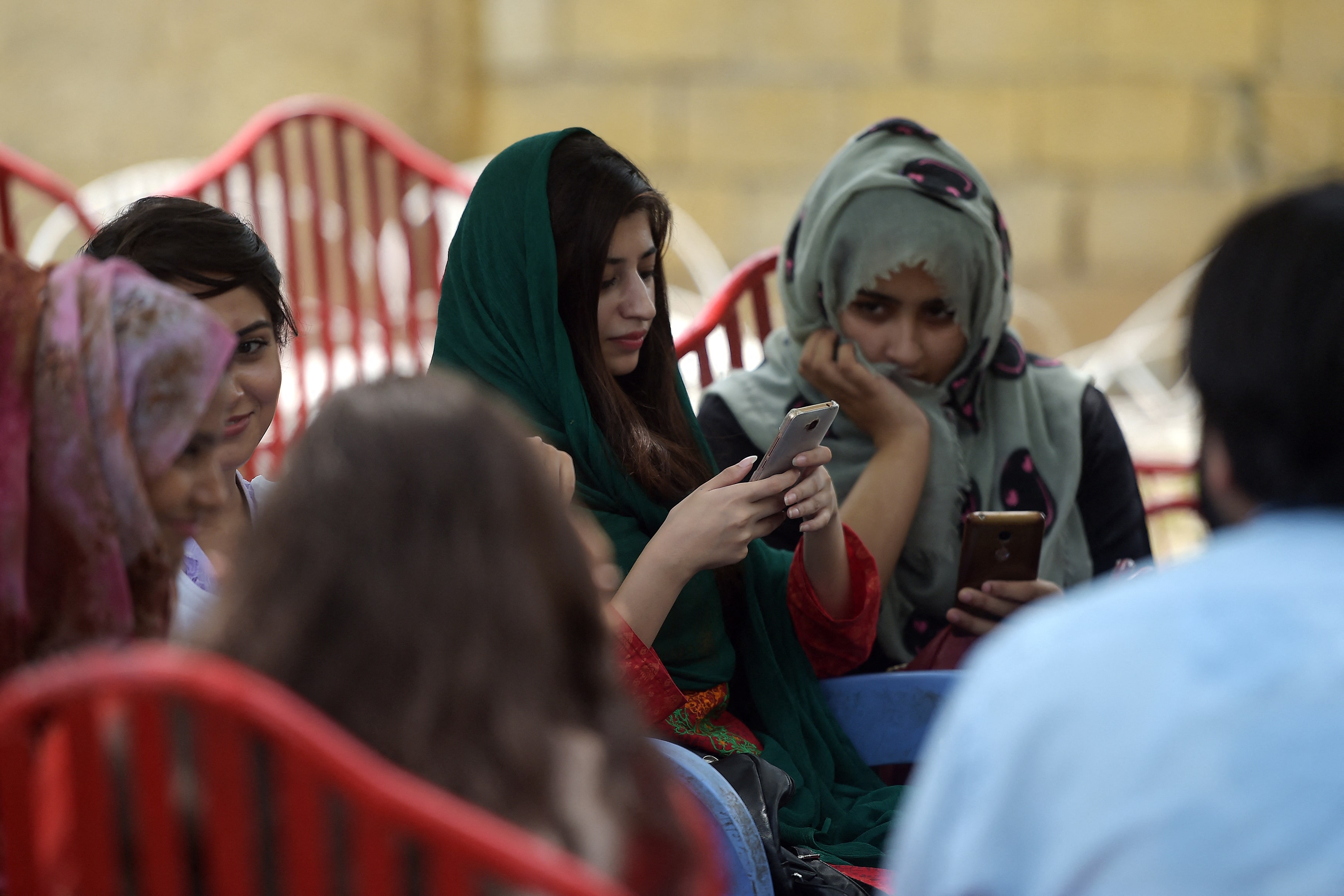 In this picture taken on July 12, 2018, students use their mobile phones at a campus in Islamabad. (AFP/File)