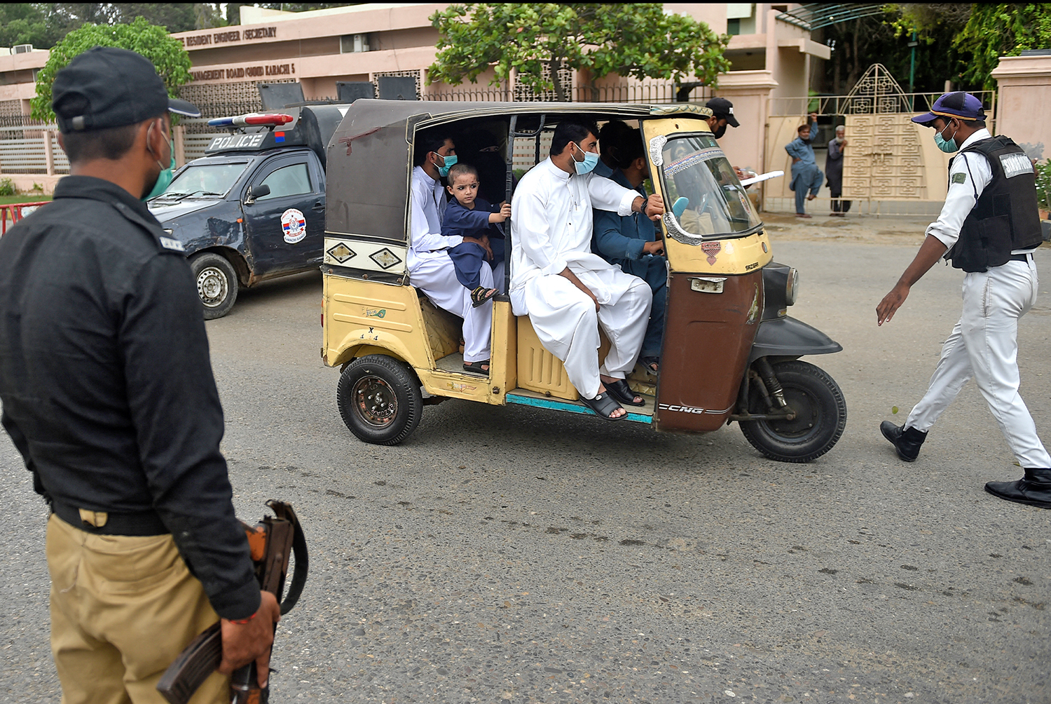 A policeman stops a auto-rickshaw to check Covid-19 vaccine certificates from passengers on a street as a partial lockdown was imposed to curb the spread of the coronavirus in Karachi, Pakistan, on August 1, 2021. (AFP/File)