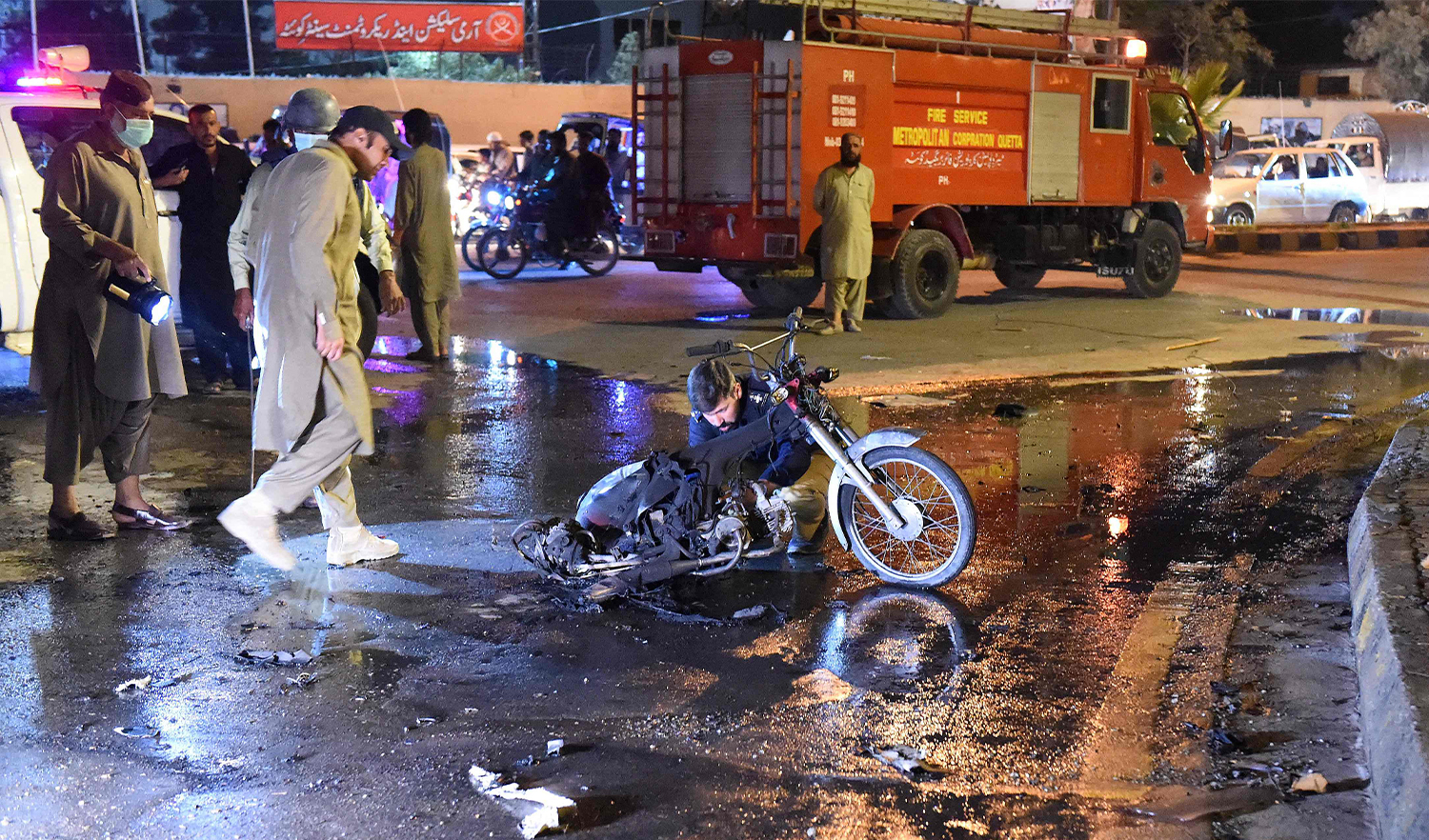 Security officials inspects the site of a bomb explosion in Quetta, Pakistan, on August 8, 2021. (AFP)