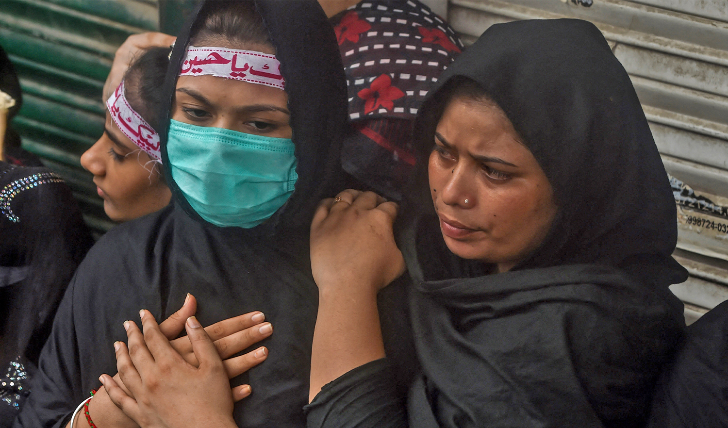 Shiite Muslims gesture while watching a mourning ritual during the Islamic month of Muharram ahead of Ashura ceremonies, in Lahore, Pakistan, on August 29, 2020. (AFP/File)