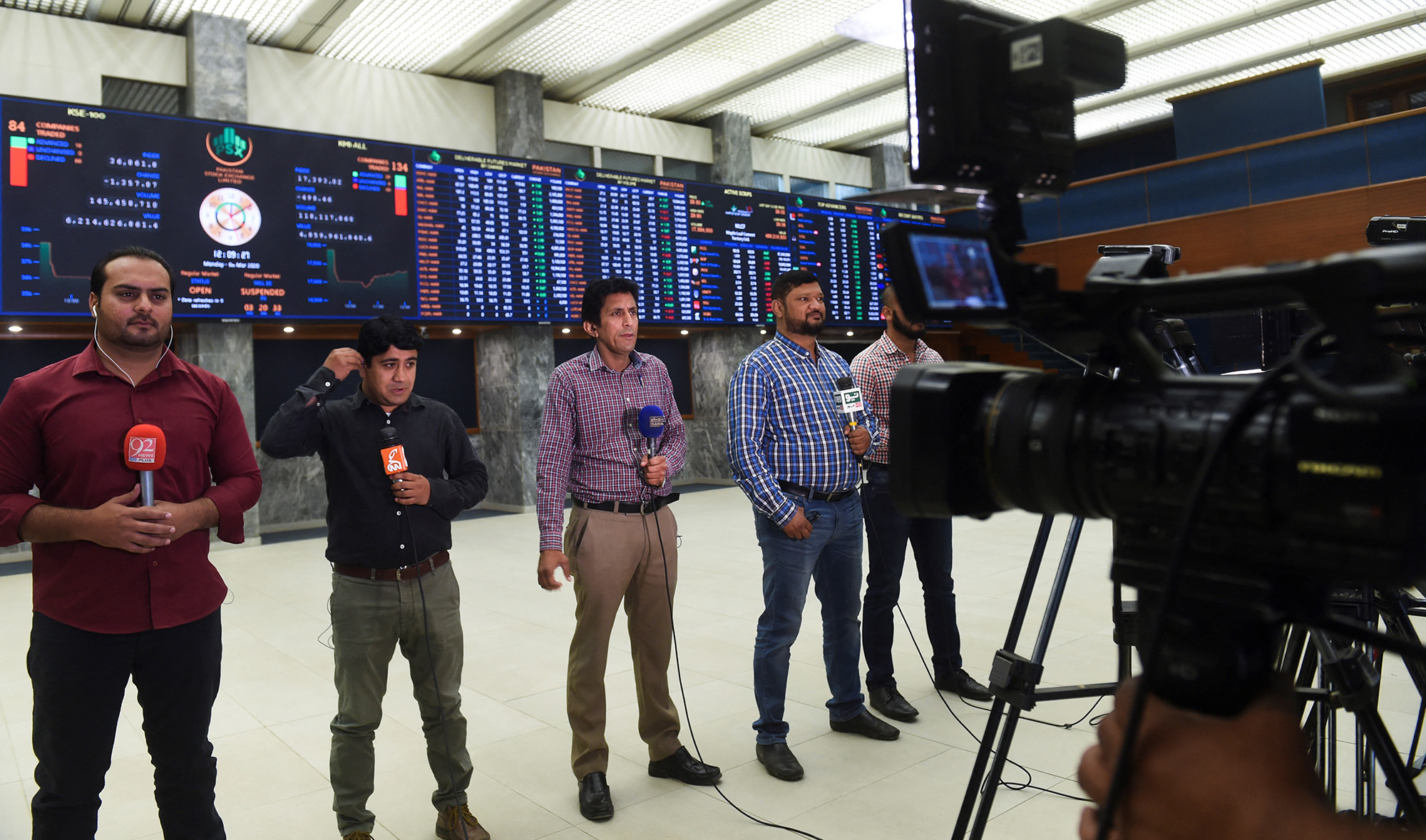 Journalists report from the trading floor at the Pakistan Stock Exchange (PSX) in Karachi on March 9, 2020. (AFP/File)