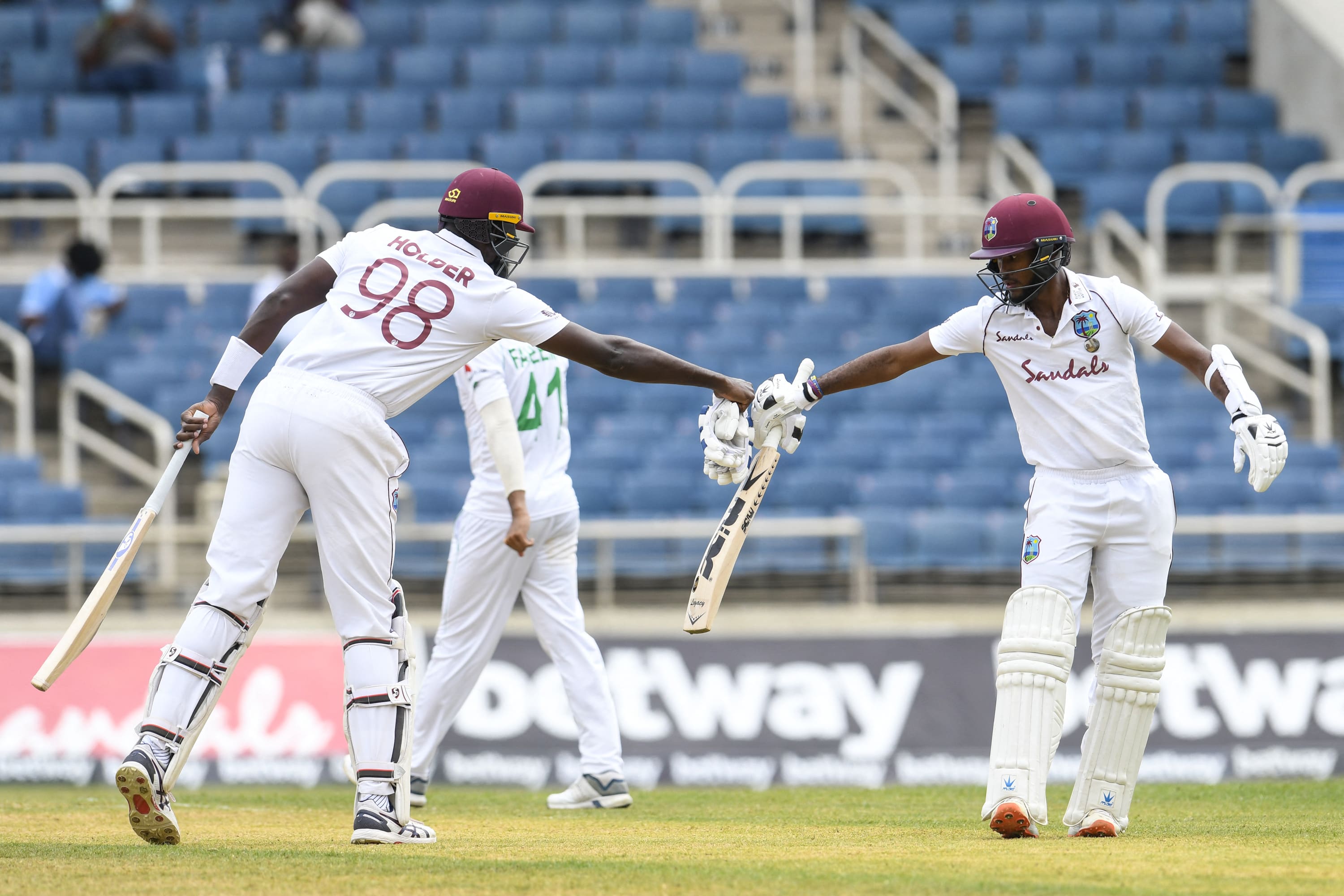 Jason Holder (L) and Kraigg Brathwaite (R) of West Indies partnership during day 2 of the 1st Test between West Indies and Pakistan at Sabina Park, Kingston, Jamaica, on August 13, 2021. (AFP)