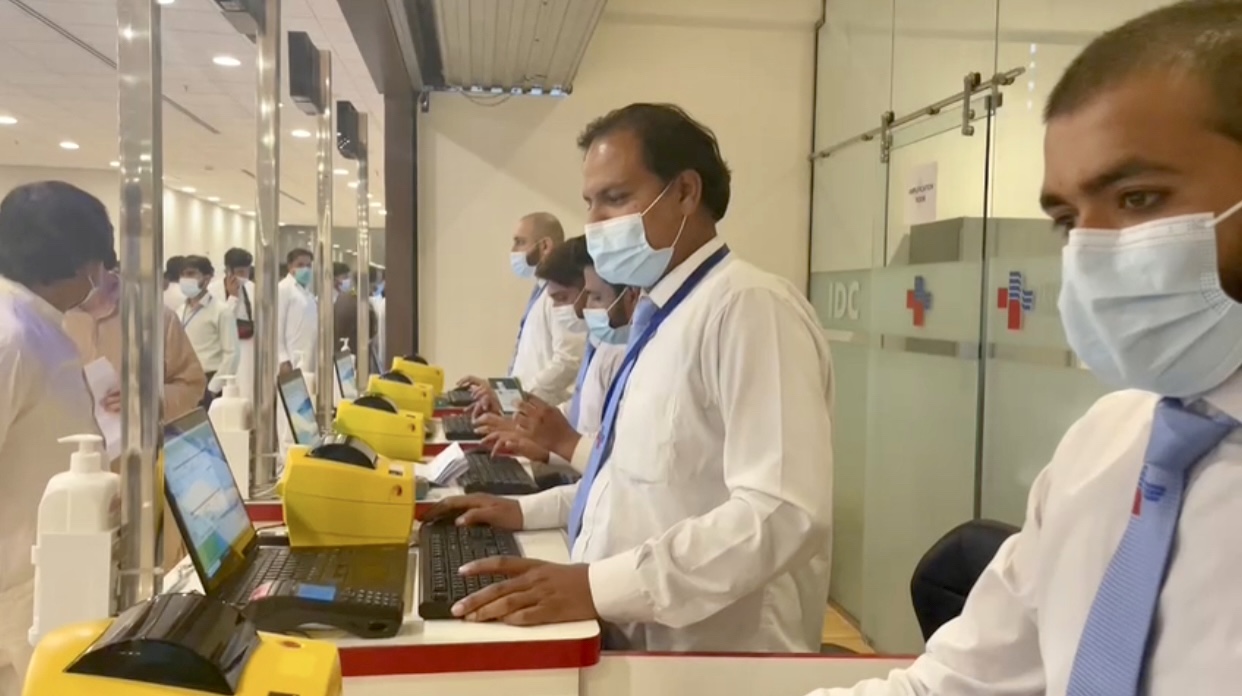 The staff of a local laboratory can be seen at the Islamabad International Airport on August 14, 2021, to provide rapid coronavirus testing facility to UAE-bound passengers. (Photo Courtesy: Islamabad Diagnostic Center)