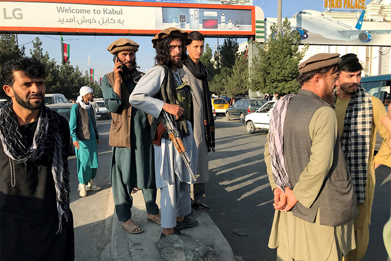 Taliban fighters stand outside Hamid Karzai International Airport in Kabul, Afghanistan, August 16, 2021. (REUTERS)