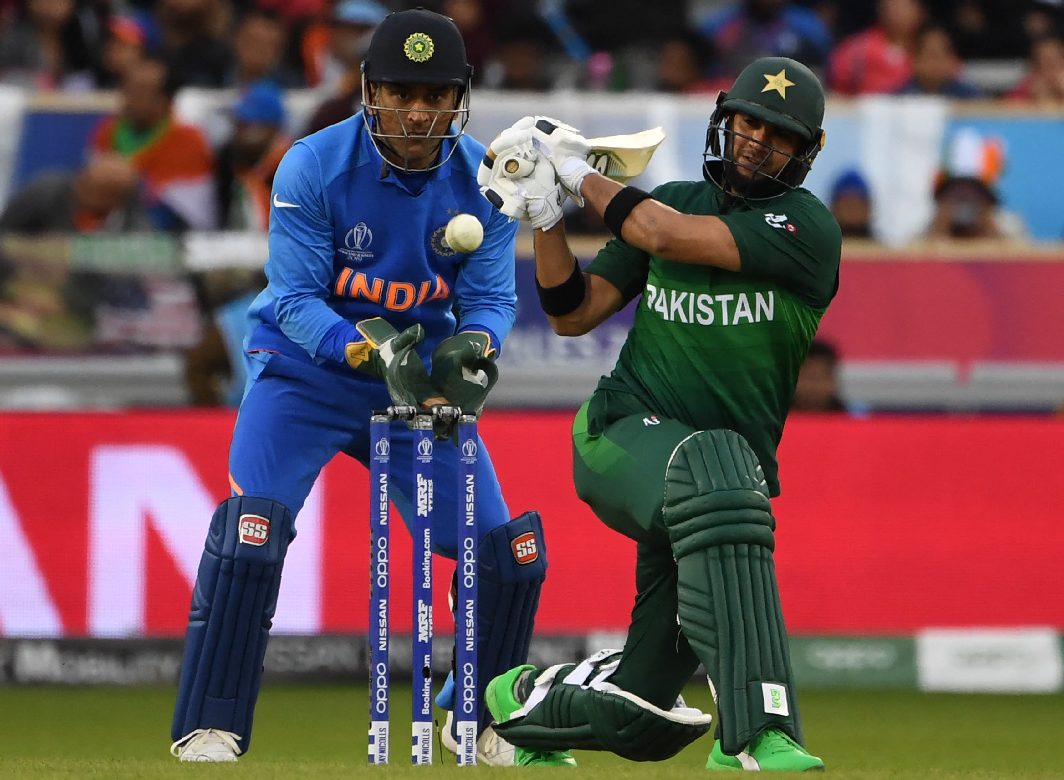 Pakistan's Rahat Ali (R) plays a shot watched by India's Mahendra Singh Dhoni during the 2019 Cricket World Cup group stage match between India and Pakistan at Old Trafford in Manchester, northwest England, on June 16, 2019. (AFP/ File)
