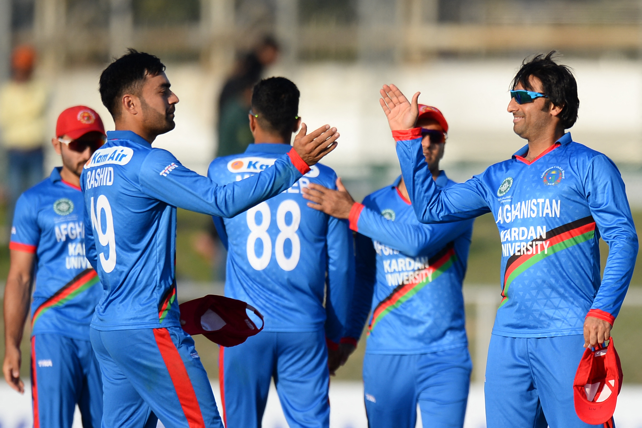 Afghanistan's captain Asghar Afghan (R) celebrates with his teammates after their win during the second T20 cricket match between Afghanistan and Ireland in Uttar Pradesh state on March 8, 2020. (AFP)