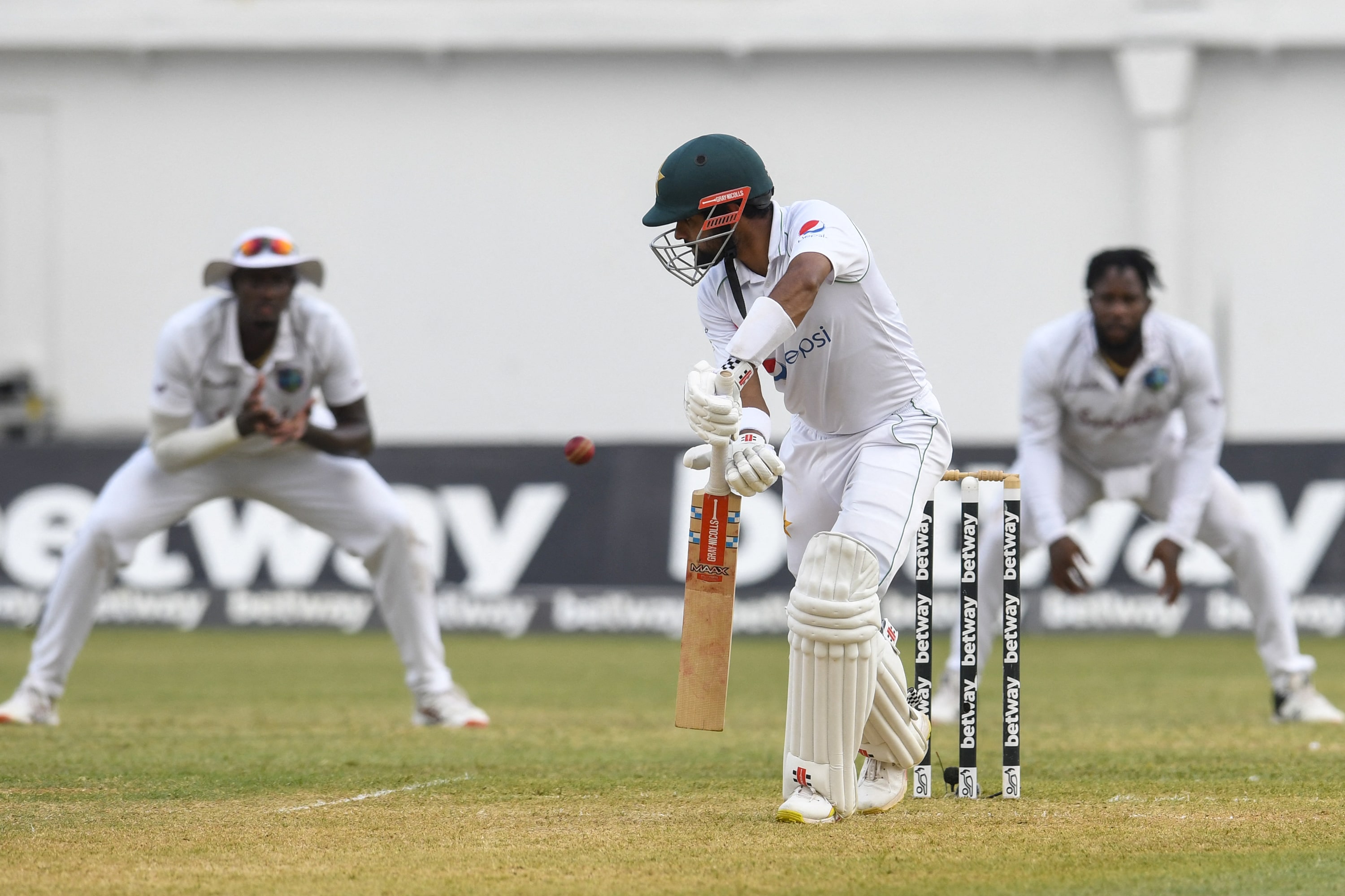 Babar Azam (C) of Pakistan about to be caught by Jason Holder (L) of West Indies during day 1 of the 2nd Test between West Indies and Pakistan at Sabina Park, Kingston, Jamaica, on August 20, 2021. (AFP)