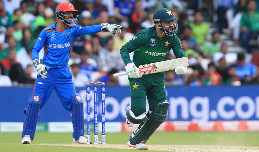 Pakistan's Shadab Khan (R) runs between the wickets as Afghanistan's wicketkeeper Ikram Ali Khil gestures during the 2019 Cricket World Cup in Leeds, northern England, on June 29, 2019. (AFP)