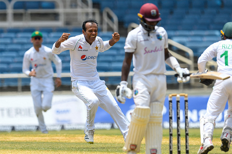 Nauman Ali (L) of Pakistan celebrates the dismissal of Jermaine Blackwood (R) of West Indies during the 5th and final day of the 2nd Test between West Indies and Pakistan in Kingston, Jamaica, on August 24, 2021. (AFP)