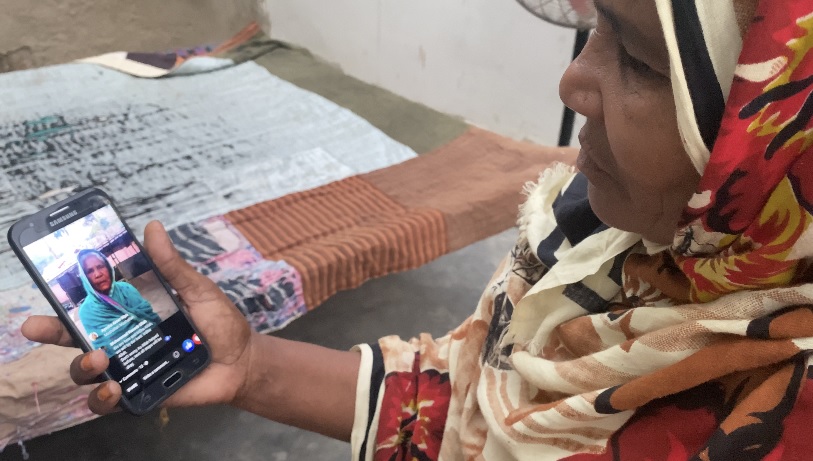 In this picture taken in Karachi on July 7, 2021, Ruqayya Begum watches a video of her mother, Razia Begum, who urged people to help her daughter travel to Bangladesh. (AN Photo)