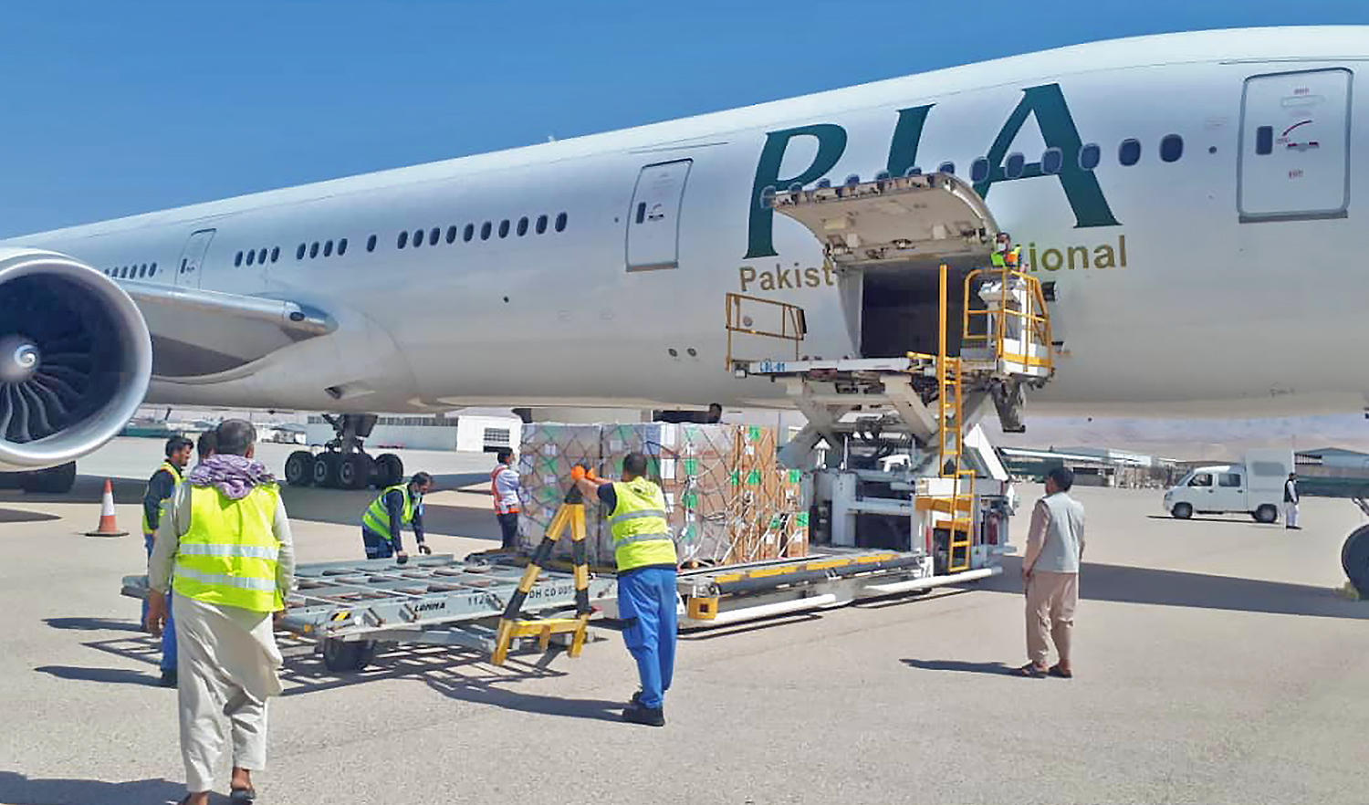 The picture released by Pakistan International Airlines (PIA) on August 30, 2021 shows workers loading medicines and supplies donated by World Health Organization to be delivered to Mazar-i-Sharif, Afghanistan. (Photo courtesy: @Official_PIA/Twitter)