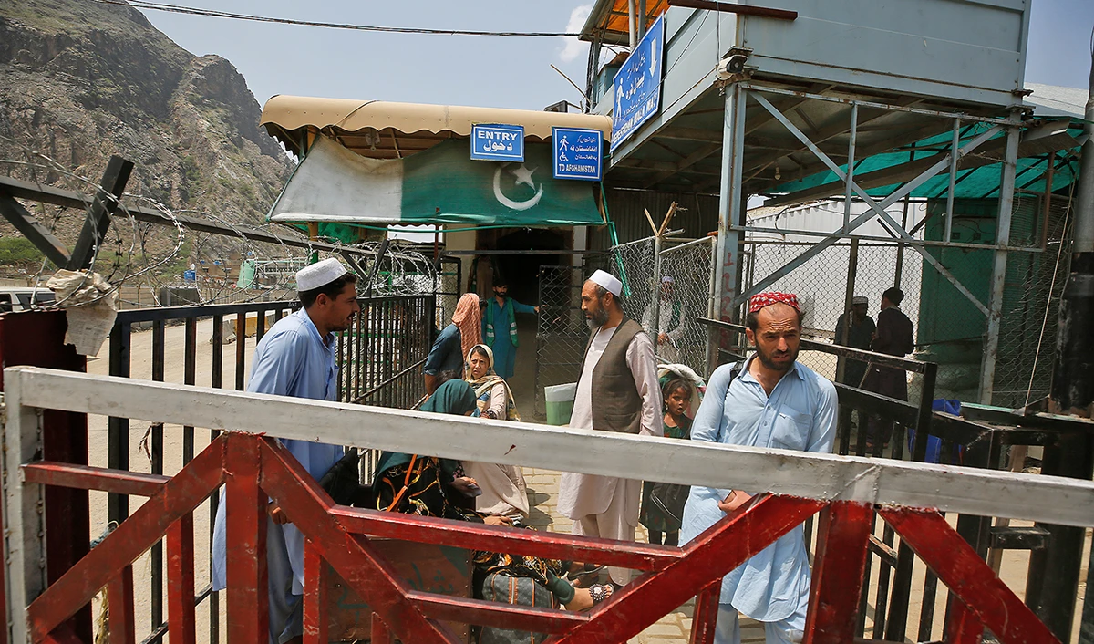 Afghan nationals wait to cross through Torkham border crossing, in Khyber district, Pakistan, on August 3, 2021. (AP)