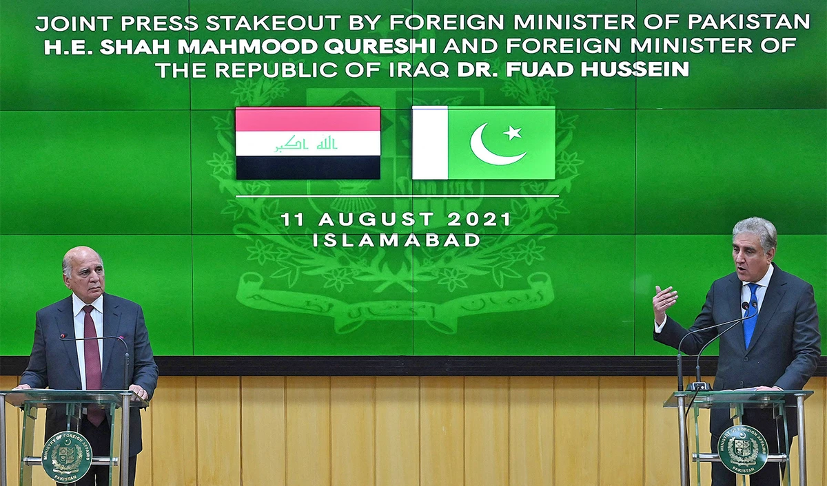 Pakistan's Foreign Minister Shah Mahmood Qureshi (R) listens as his Iraqi counterpart Fuad Hussein (L) speaks during a press conference after a meeting during his visit in Islamabad, Pakistan, on August 11, 2021. (AFP)