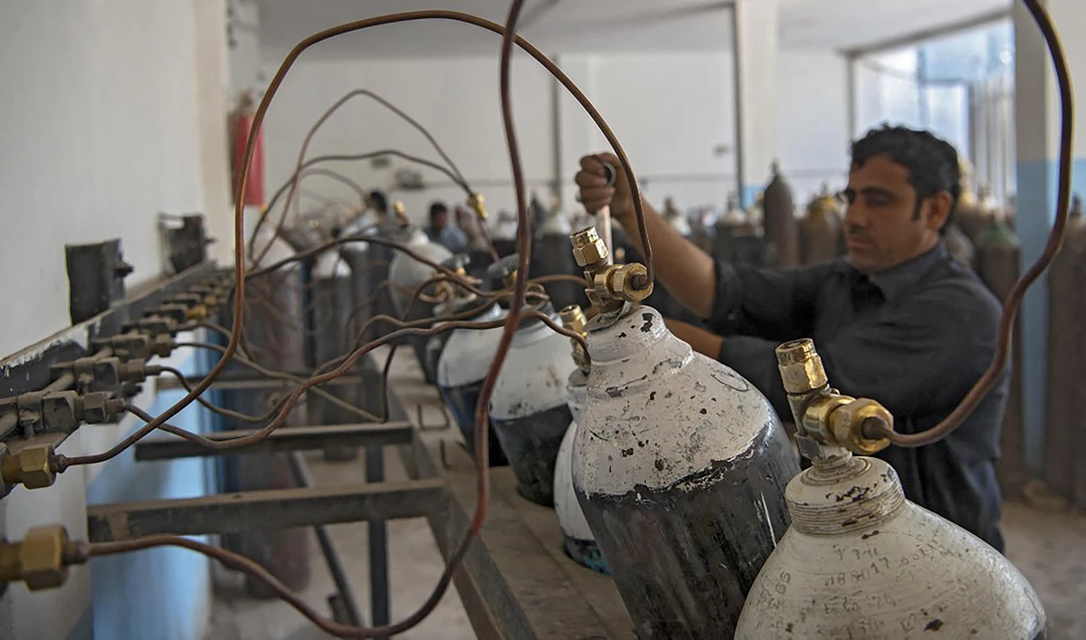 A worker fills oxygen cylinders for hospital use on coronavirus patients, at a factory in Peshawar, Pakistan on April 12, 2021. (AFP/File)