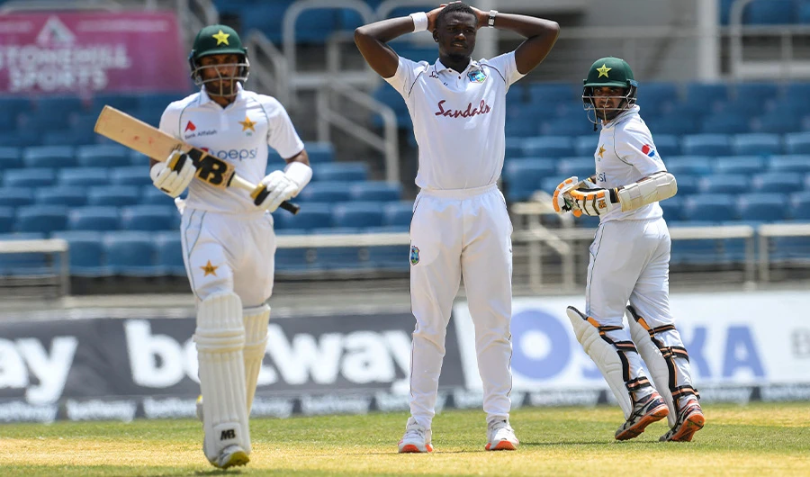 Jayden Seales (C) of West Indies expresses disappointment as Abid Ali (R) and Imran Butt (L) of Pakistan run during day 4 of the 2nd Test between West Indies and Pakistan at Sabina Park, Kingston, Jamaica, on August 23, 2021. (AFP)