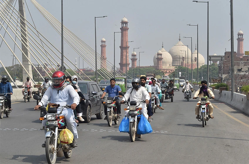 Commuters make their way along a street after the government eased a nationwide lockdown imposed as a preventive measure against the COVID-19 coronavirus, in Lahore on May 12, 2020. (AFP/ File)