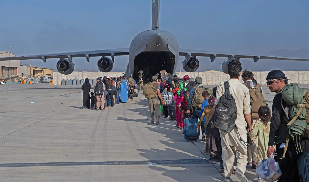 US Air Force loadmasters and pilots load passengers aboard a US Air Force aircraft in support of the Afghanistan evacuation at Hamid Karzai International Airport, Afghanistan on August 24, 2021. (AFP)