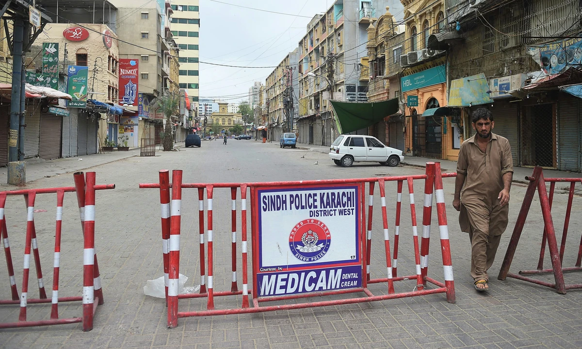 A man walks in a closed market as a partial lockdown was imposed to curb the spread of the Covid-19 coronavirus in Karachi on August 1, 2021. (AFP)