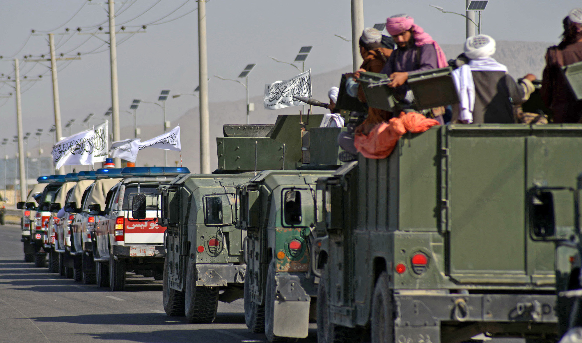 Taliban fighters stand on an armoured vehicle as they parade along a road to celebrate after the US pulled all its troops out of Afghanistan, in Kandahar on September 1, 2021 following the Taliban’s military takeover of the country. (AFP)