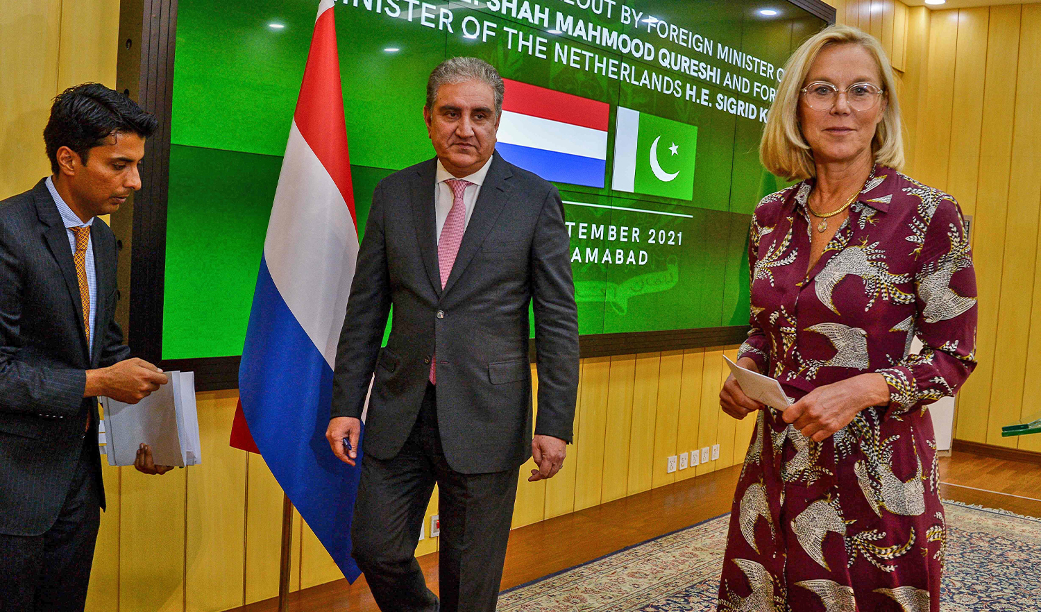 Dutch Foreign Minister Sigrid Kaag (R) and Pakistan's Foreign Minister Shah Mahmood Qureshi (C) leave after addressing a press conference after their meeting in Islamabad, Pakistan, on September 1, 2021. (AFP)