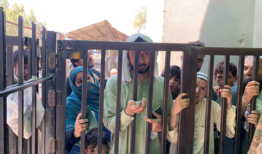 Pakistani Shafiq Mohammad, 40, stands with his passport and identity cards of his family members, at a closed pedestrian crossing gate at Pakistan-Afghanistan crossing border, in Torkham, Pakistan September 2, 2021. (REUTERS)