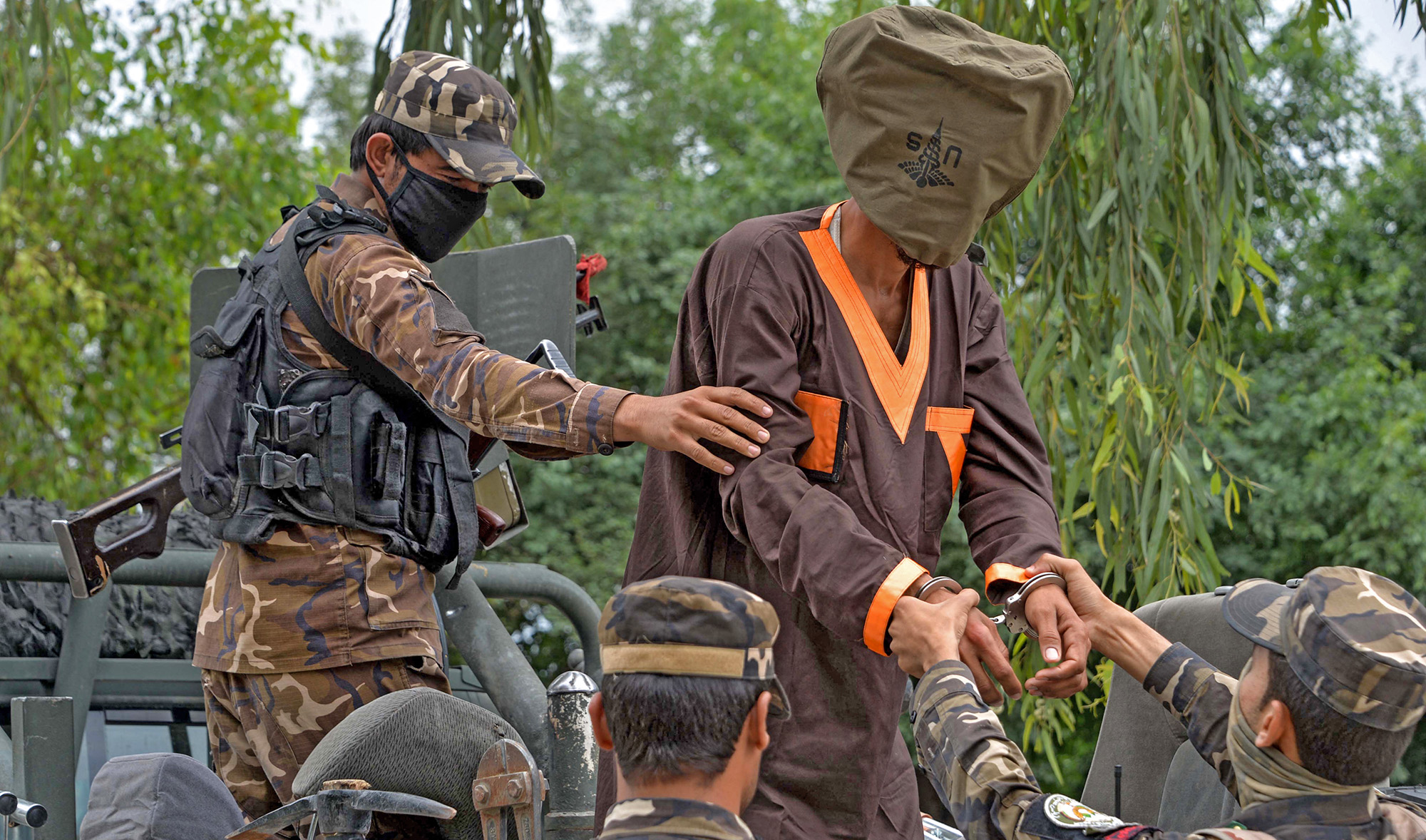 Forces with Afghanistan's National Directorate of Security (NDS) escort an alleged militant in Jalalabad, Afghanistan, on May 23, 2019. (AFP/File)