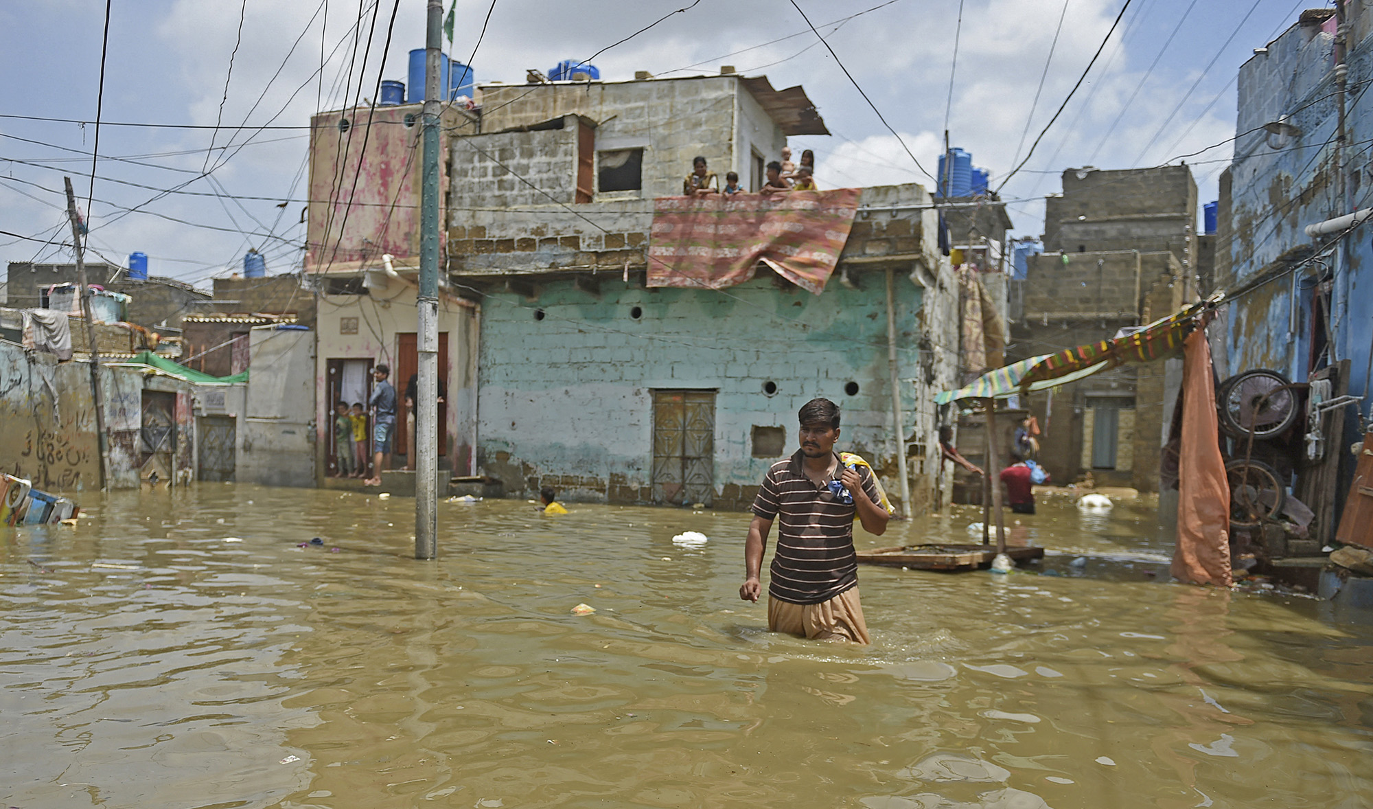 A man wades through a flooded street after heavy monsoon rains in the Pakistan's port city of Karachi on August 22, 2020. (AFP/File)