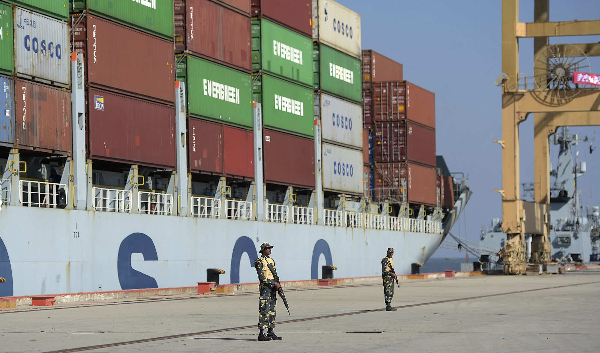 In this photograph taken on November 13, 2016, Pakistani Naval personnel stand guard near a ship carrying containers at the Gwadar port, some 700 kms west of Karachi. (AFP/File)