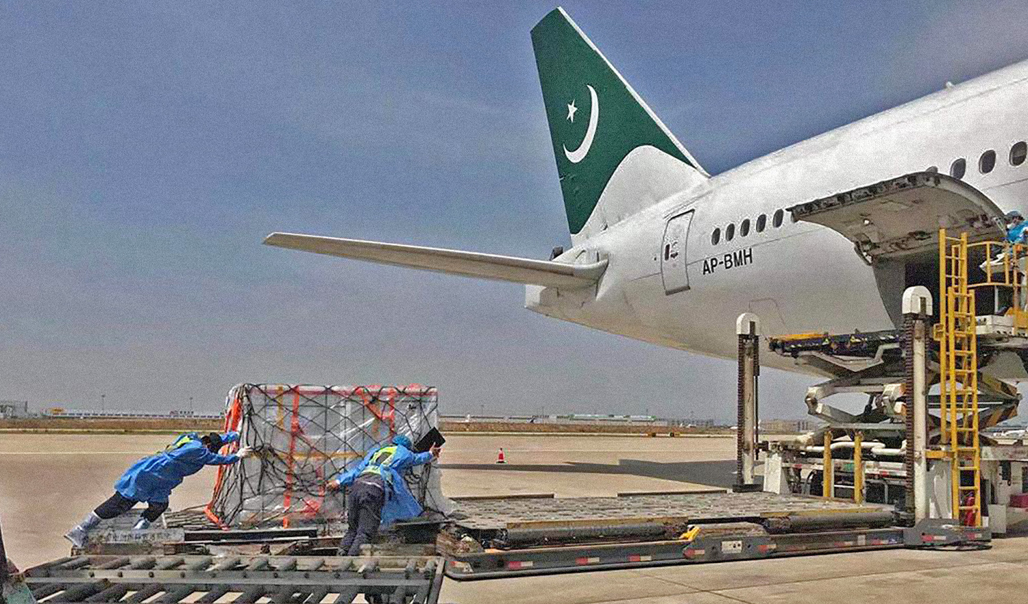 Workers off load boxes of COVID-19 vaccine from Pakistan International Airlines' (PIA) aircraft in Islamabad, Pakistan, on May 9, 2021. (Photo courtesy: PIA/File)