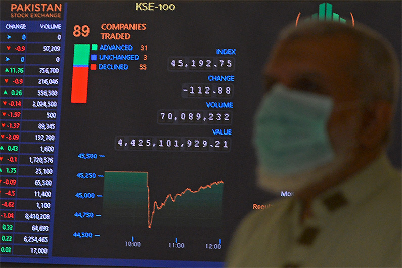 A stockbroker watches the latest share prices during a trading session at the Pakistan Stock Exchange (PSX) in Karachi on April 19, 2021. (AFP)