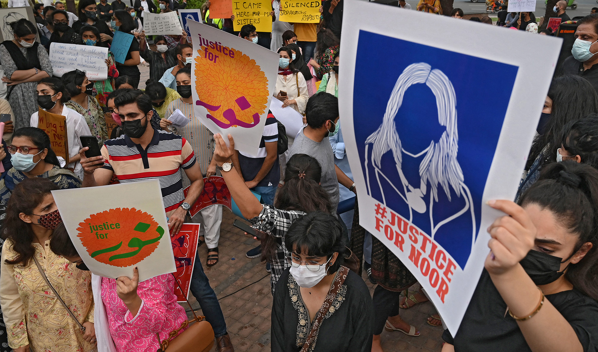 Women rights activists hold placards during a demonstration in Lahore on July 24, 2021, against the brutal killing of Noor Mukadam in Islamabad. (AFP/File)