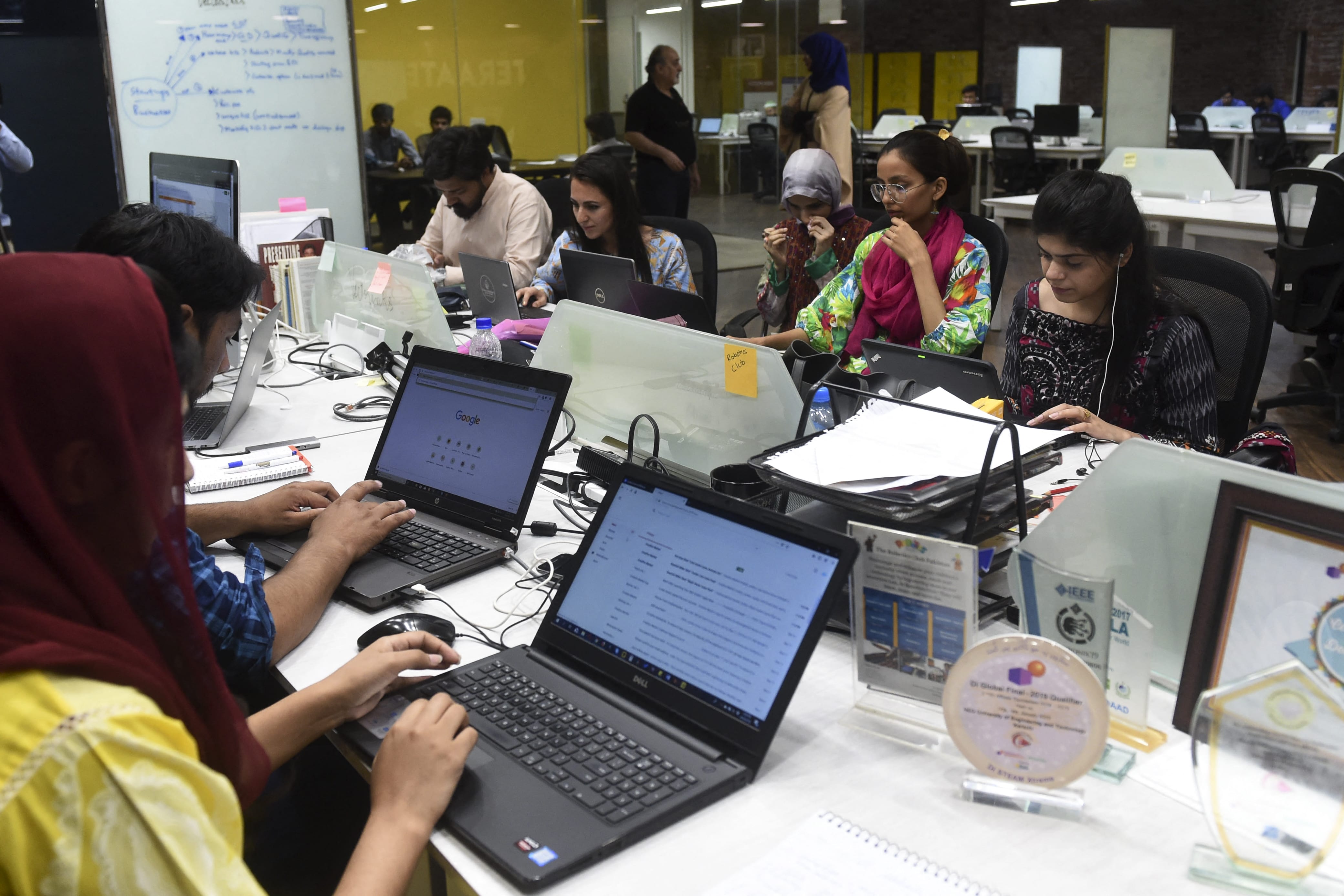 In this photograph taken on May 24, 2019, People work at their stations at the National Incubation Centre (NIC), a start-up incubator, in Lahore. (AFP/ File)
