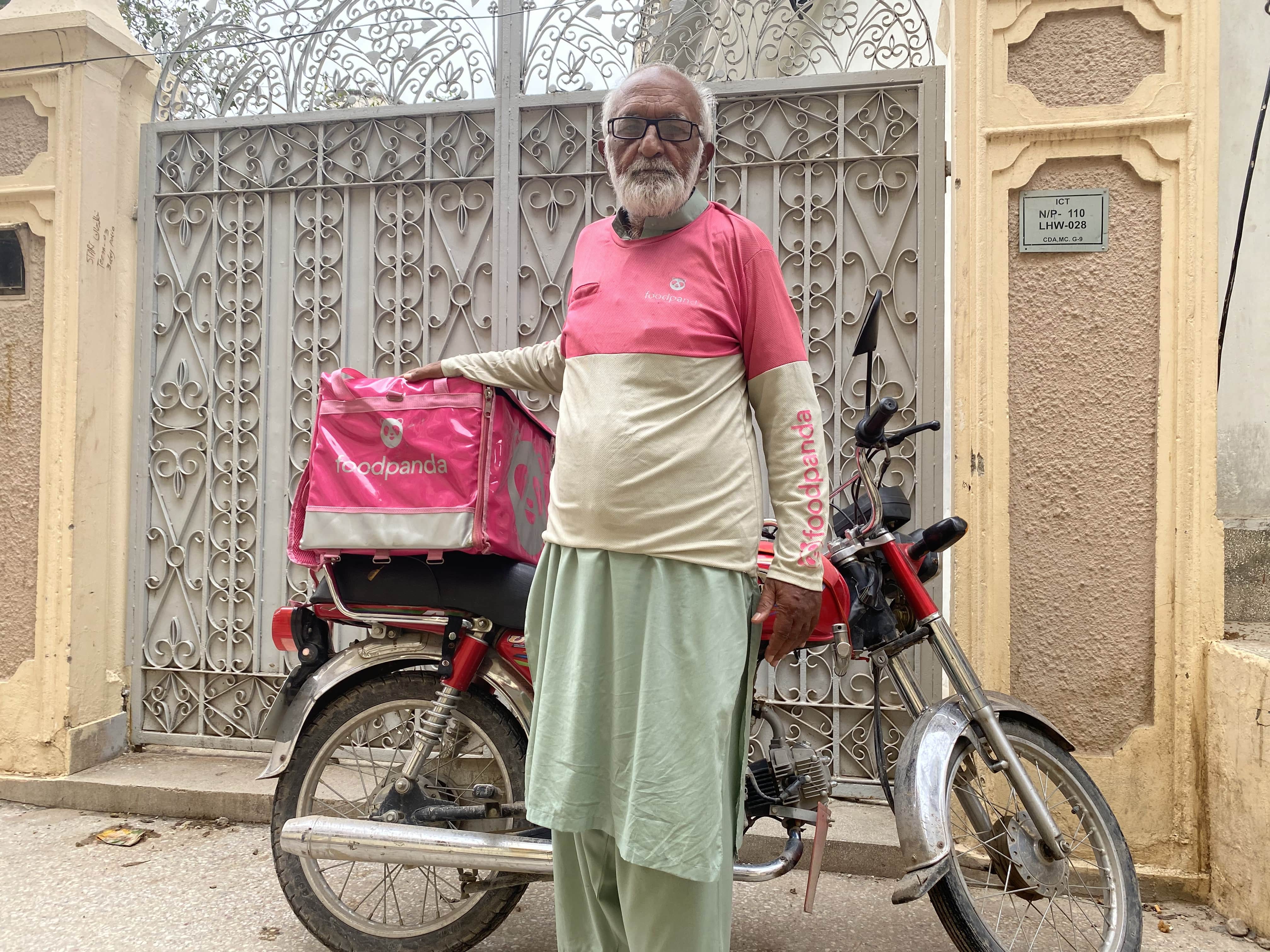 Fayyaz Akhter Faizi, 73, who works as a food rider, is seen wearing the signature Food Panda uniform at his residence in Islamabad, Pakistan, on September 8, 2021. (AN photo)
