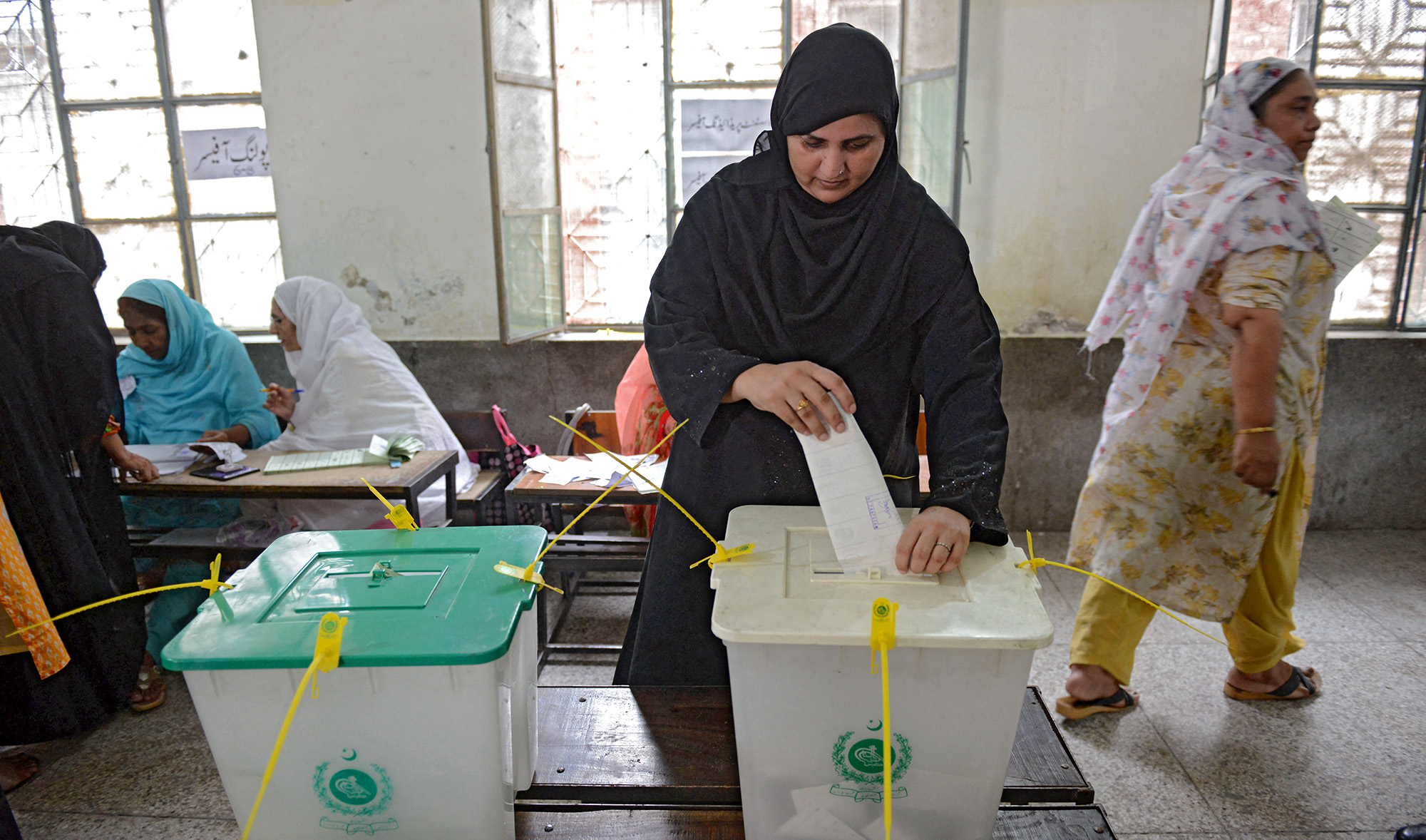 A woman casts her vote during Pakistan's general election at a polling station during the general election in Lahore on July 25, 2018. (AFP/File)