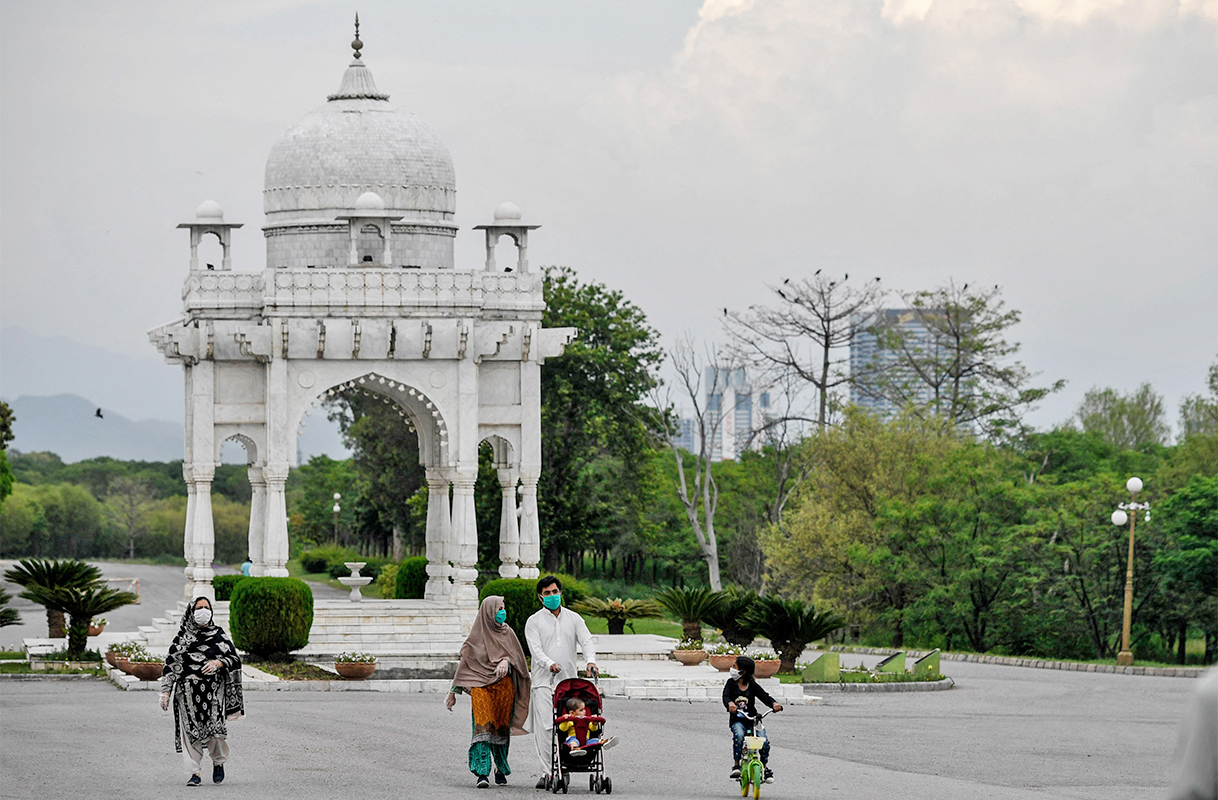 People wearing facemasks walk at the Fatima Jinnah Park in Islamabad, Pakistan, on April 29, 2020. (AFP/File)