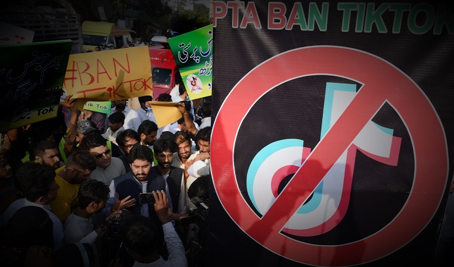 Activists of the Jamhoori Wattan Party carry placards during a protest to demand the ban of TikTok social media, in Lahore on June 18, 2021. (AFP)