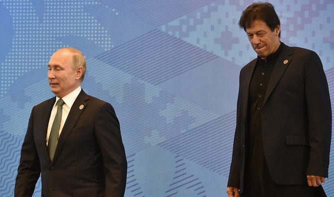 Russian President Vladimir Putin and Pakistani Prime Minister Imran Khan leave after posing for a photo prior to a meeting of the Shanghai Cooperation Organisation (SCO) Council of Heads of State in Bishkek on June 14, 2019. (AFP/File)