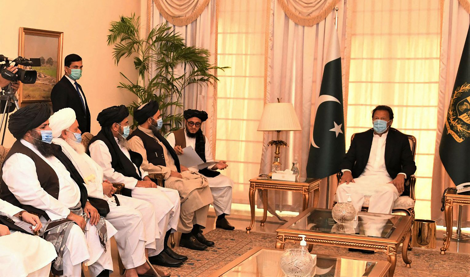 Pakistani Prime Minister Imran Khan, right, along with Taliban co-founder Mullah Abdul Ghani Baradar, fifth left, and his delegation during their meeting in Islamabad on December 18, 2020. (Photo courtesy: Pakistan Prime Minister Office)