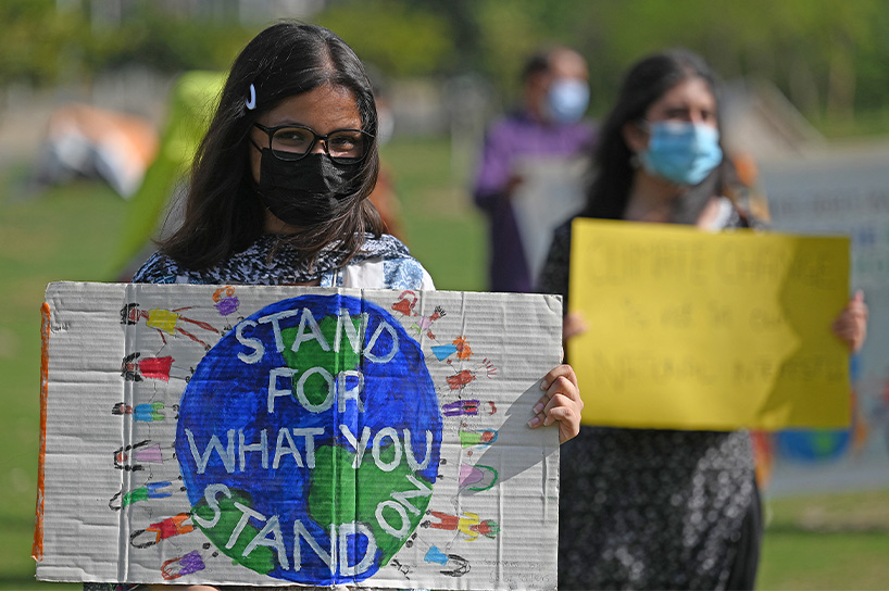 Climate activists hold placards as they take part in a demonstration in support of the environmental and climate protection movement ‘Fridays for Future’ in Islamabad on March 19, 2021. (AFP)