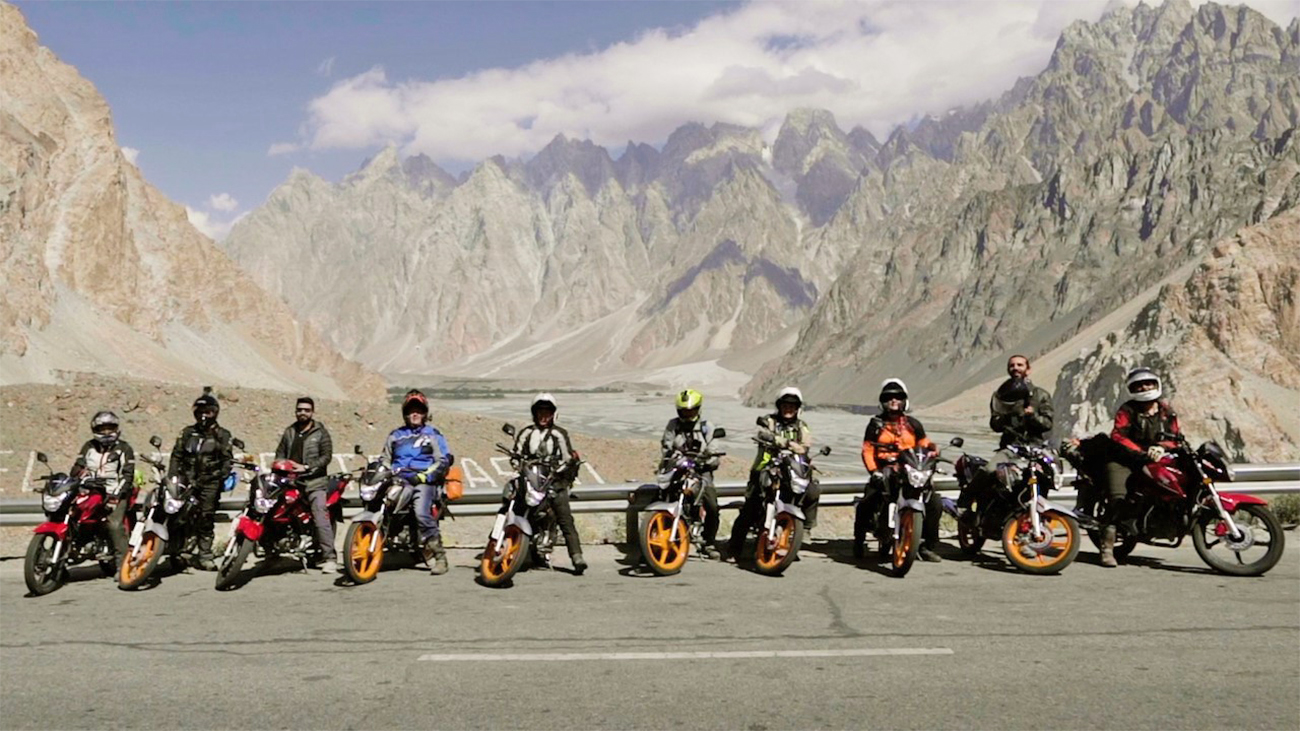 Members of Chickistan, a motorcycling tour group founded by Liza Miller from the United States and Pakistani biker Moin Khan, pose for a photo while entering Passu village in Gilgit-Baltistan, Pakistan, on September 10, 2021. (Photo courtesy: Moin Khan)