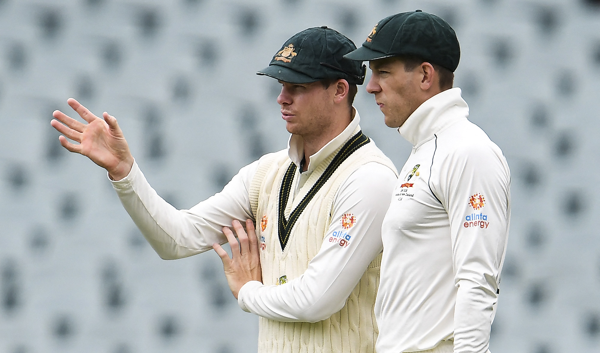 Australia's Steve Smith (L) speaks with captain Tim Paine (R) on the third day of the second cricket Test match against Pakistan in Adelaide on December 1, 2019. (AFP/File)