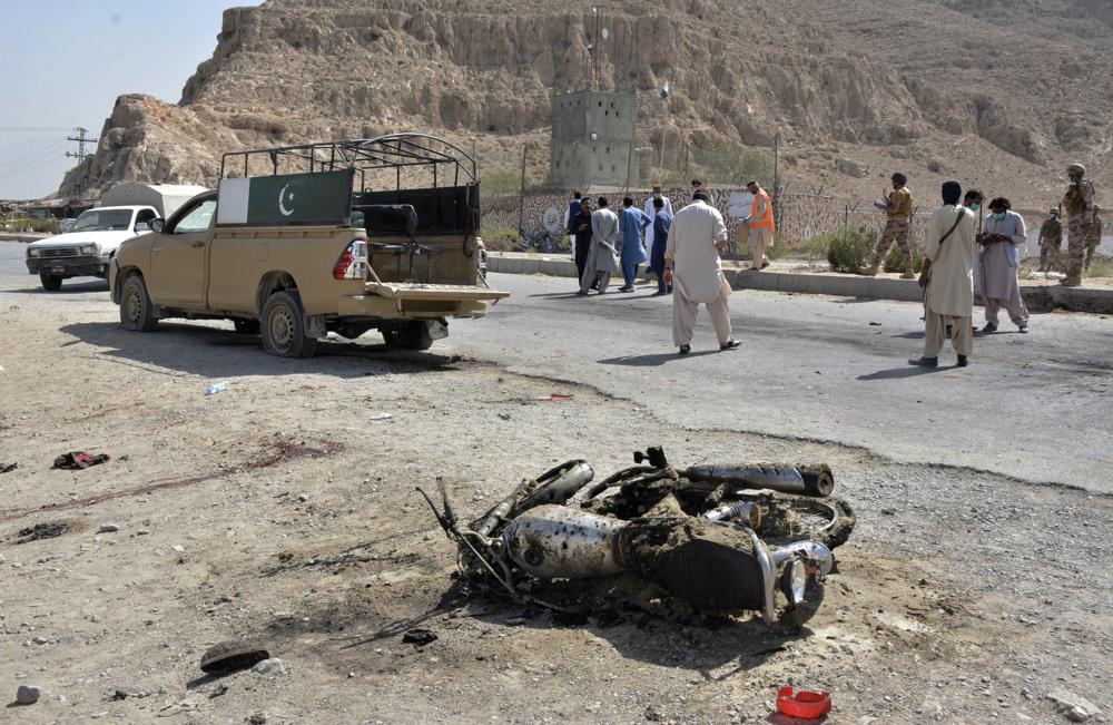 Security officials examine the site of suicide bombing in a checkpoint on the outskirts of Quetta, Pakistan, Sunday, Sept. 5, 2021. (AFP)