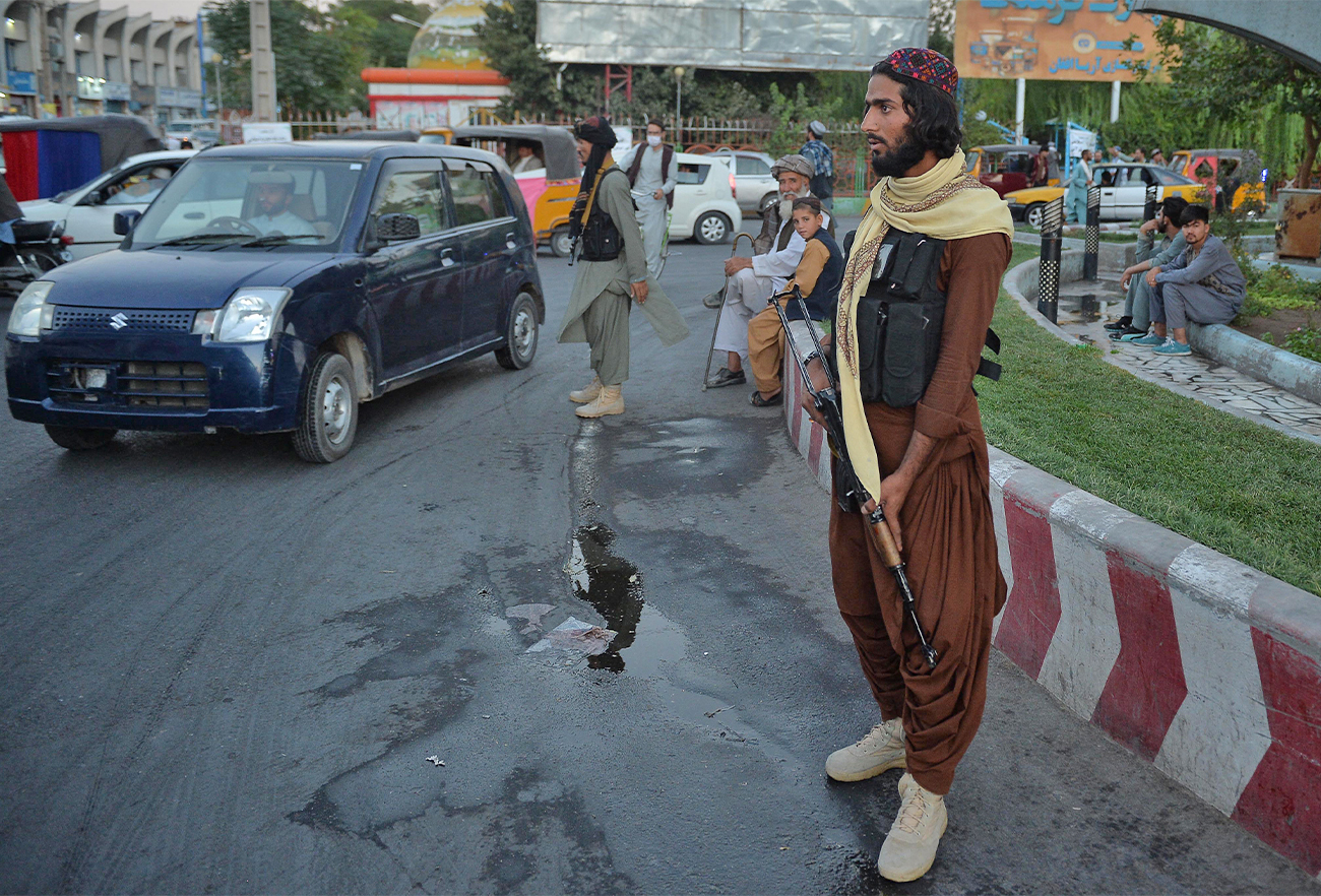 Taliban fighters stand guard along a road in Herat, Afghanistan, on September 21, 2021. (AFP/File)