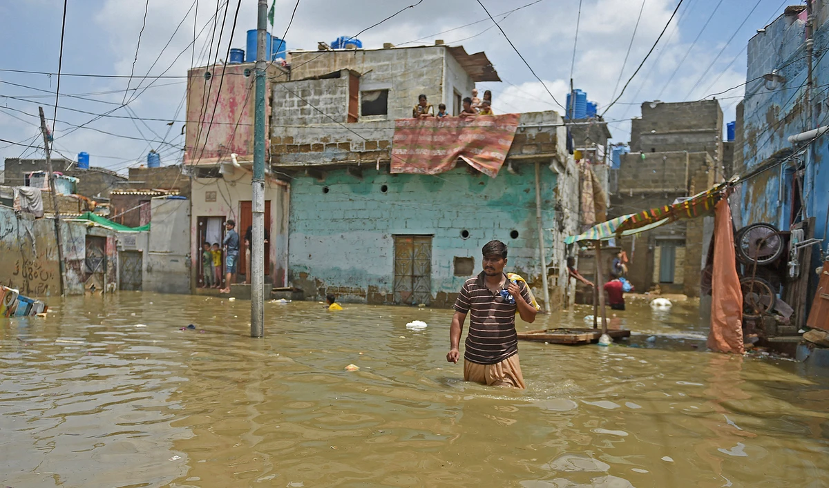 A man wades through a flooded street after heavy monsoon rains in the Pakistan's port city of Karachi on August 22, 2020. (AFP/File)