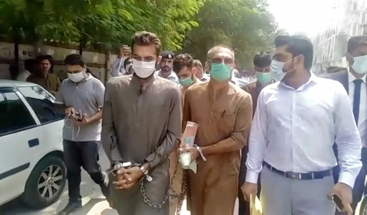 A handcuffed Zahir Zakir Jaffer (left), key suspect in the July murder of Noor Mukadam, and Jaffer's father (second right), also handcuffed, are led by Islamabad police after a court hearing in Islamabad, Pakistan, on September 6, 2021. (Photo courtesy: Social Media)