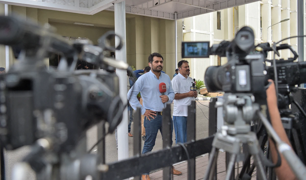 Pakistani journalists broadcast live news in Islamabad, Pakistan, on June 28, 2018. (AFP/File)
