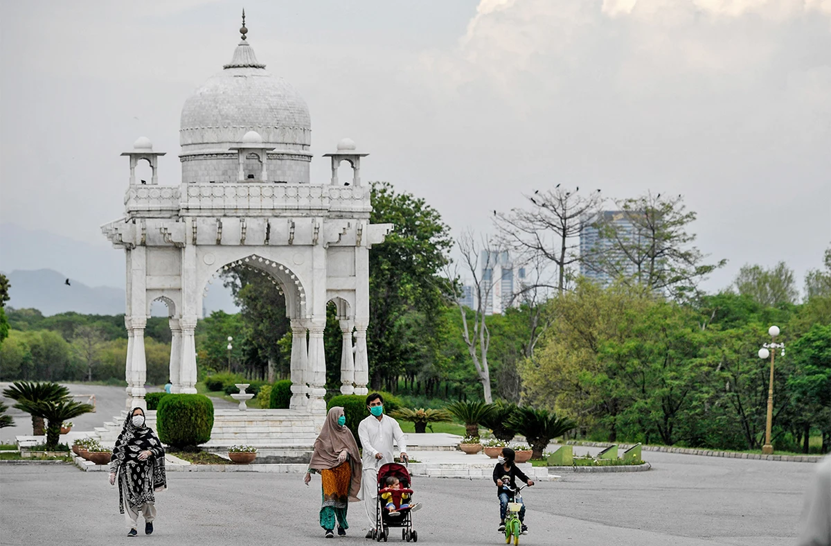 People wearing facemasks walk at the Fatima Jinnah Park in Islamabad, Pakistan, on April 29, 2020. (AFP/File)