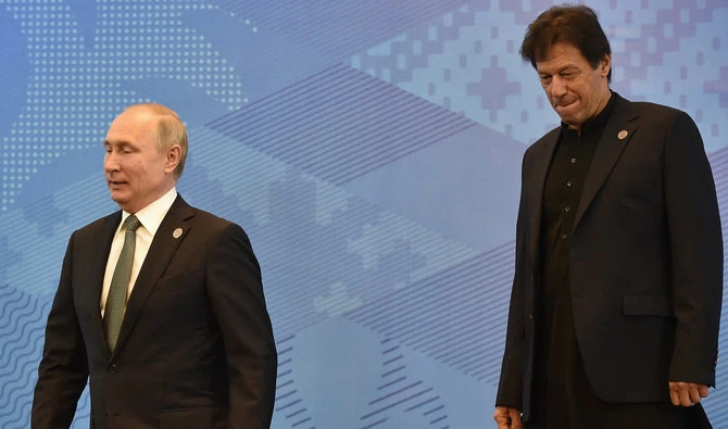 Russian President Vladimir Putin and Pakistani Prime Minister Imran Khan leave after posing for a photo prior to a meeting of the Shanghai Cooperation Organisation (SCO) Council of Heads of State in Bishkek on June 14, 2019. (AFP/File)