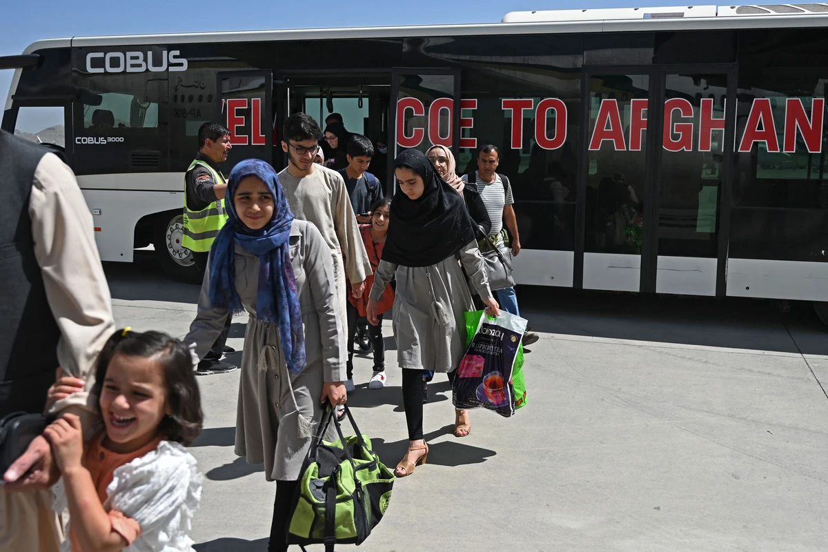 Passengers disembark from a shuttle bus to board a Pakistan International Airlines (PIA) flight, the first commercial international flight since the Taliban retook power last month, at the airport in Kabul on September 13, 2021. (AFP)