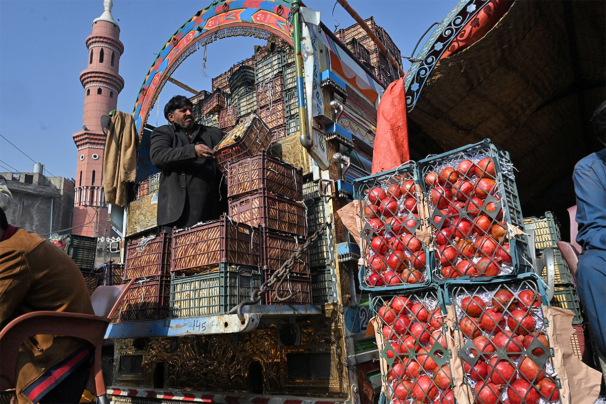 A trader arranges pomegranate on his truck at a fruit market in Lahore, Pakistan, on January 31, 2021. (AFP/File)